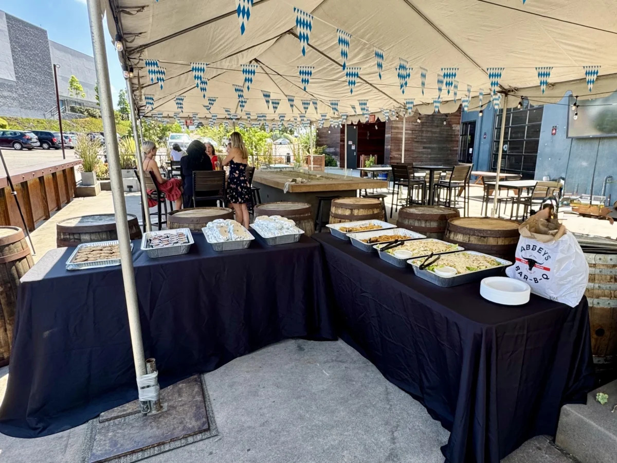 Abbey’s Real Texas BBQ catering event setup in San Diego with slow-smoked brisket, ribs, and sides